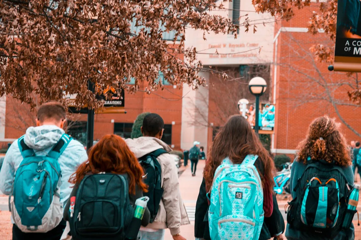 Estudante com mala em frente a universidade europeia representando intercâmbio acadêmico internacional
