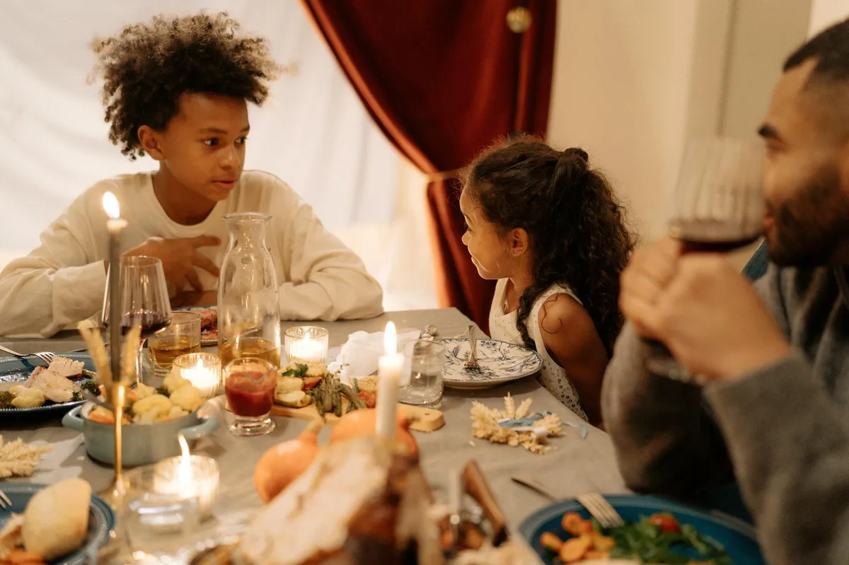 Família reunida conversando à mesa de jantar