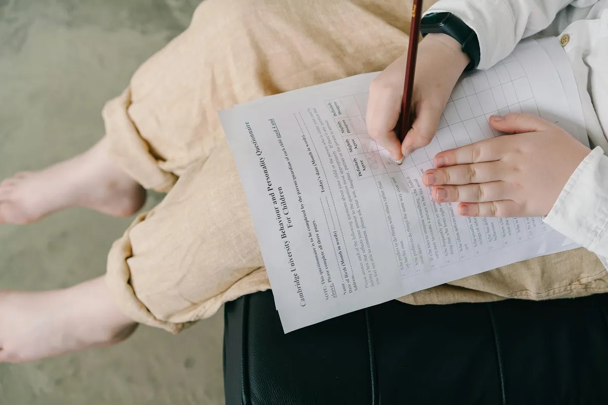 Pesquisadora analisando questionário de pesquisa em mesa de trabalho com documentos
